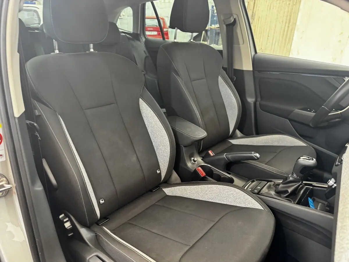 Vue intérieure côté avant droit de la Skoda Scala 1.0 TSI 116ch DSG7 gris clair, sièges tissu bicolore noir et gris.