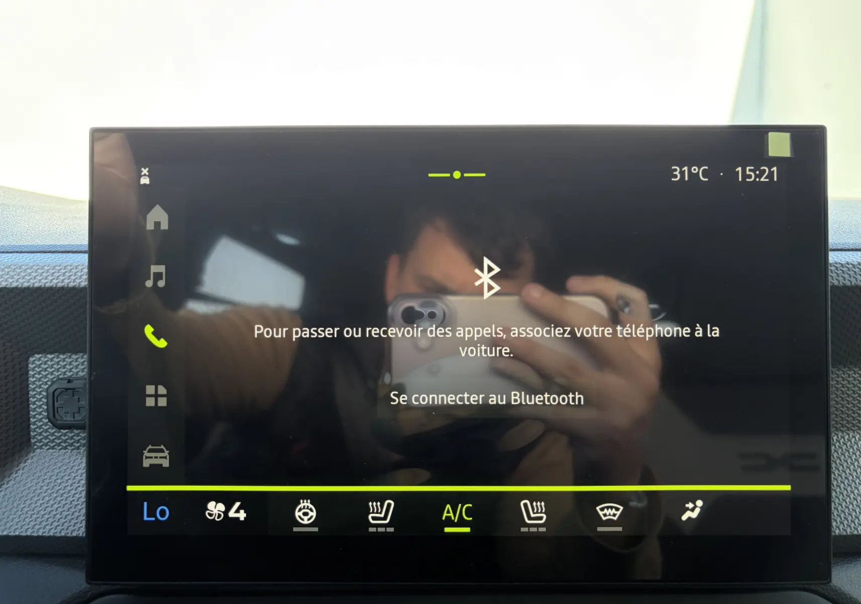 Écran tactile central du tableau de bord du Dacia Duster III 2026 affichant la connexion Bluetooth et la climatisation.