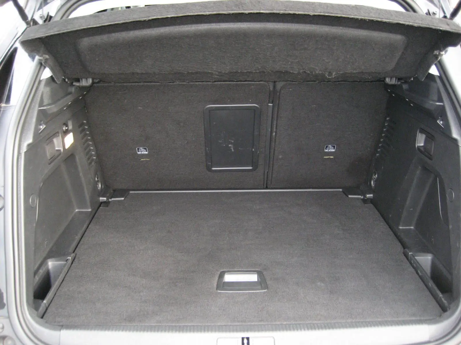 Coffre spacieux noir du Peugeot 3008 Business 2020 vu de l'arrière avec banquette arrière rabattue.