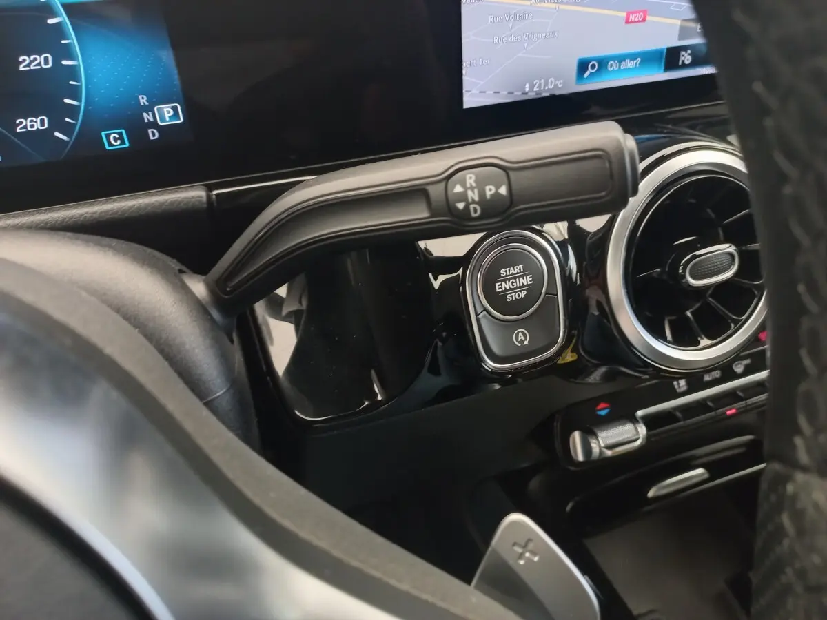 Gros plan sur la commande de boîte automatique et bouton Start/Stop du tableau de bord noir de la Mercedes Classe A AMG Line.