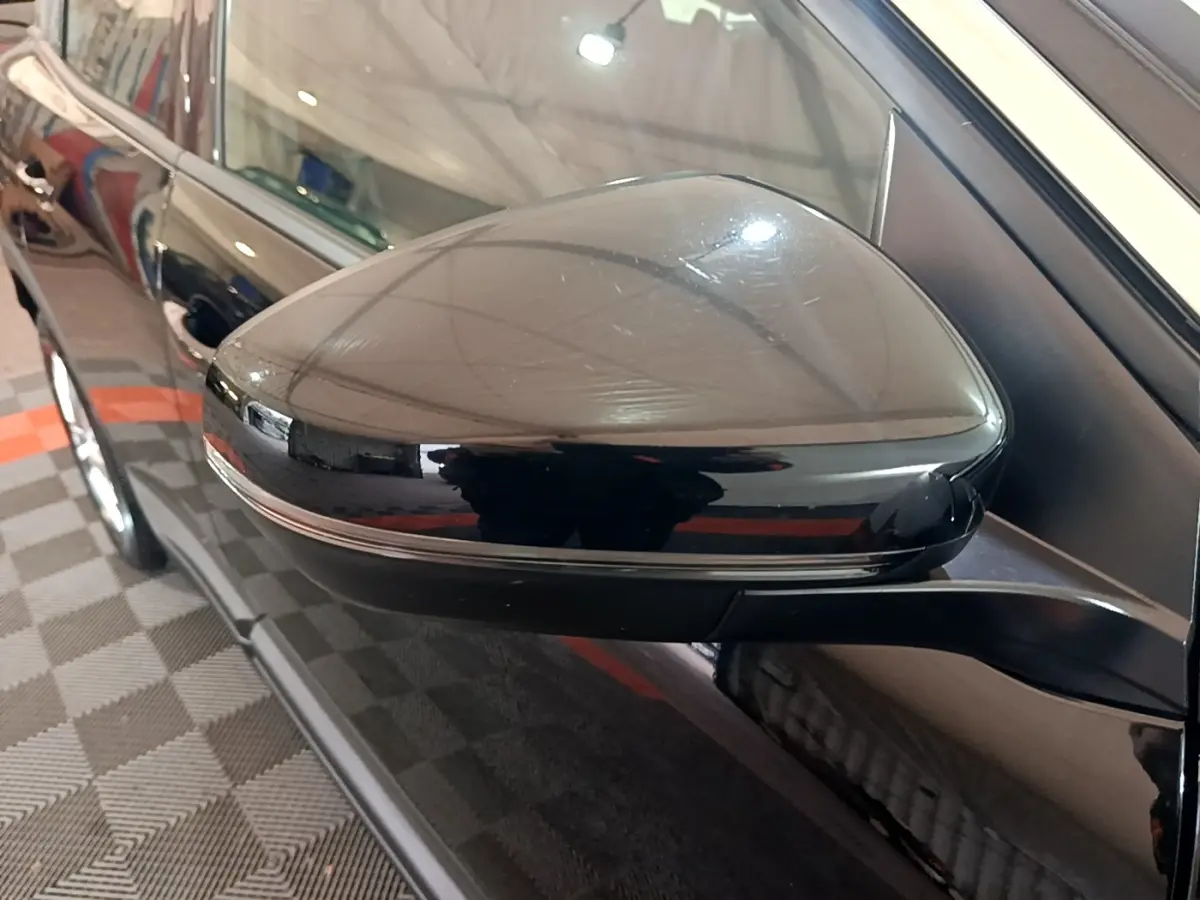 Rétroviseur côté gauche noir brillant du Peugeot 3008 2022, avec carrosserie noire et reflets intérieurs visibles.