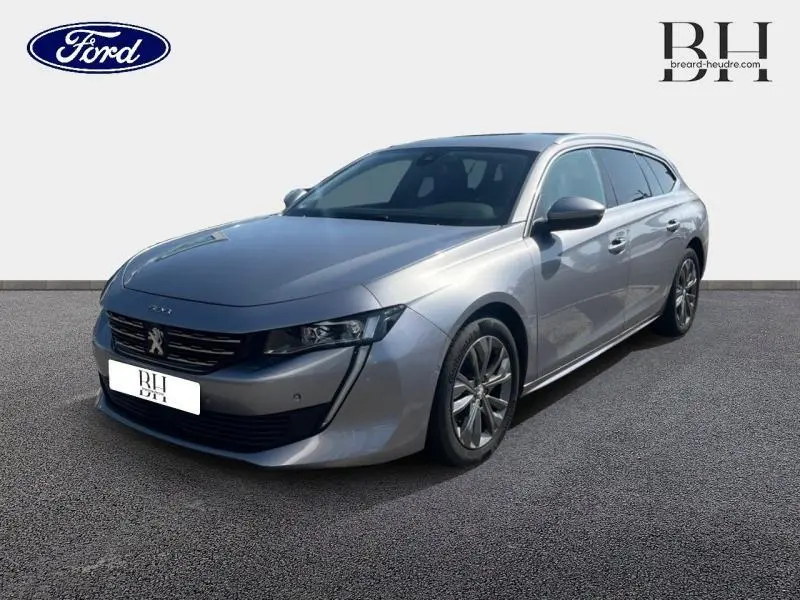Peugeot 508 SW gris Artense vue 3/4 avant droit, avec calandre chromée et jantes alliage visibles.