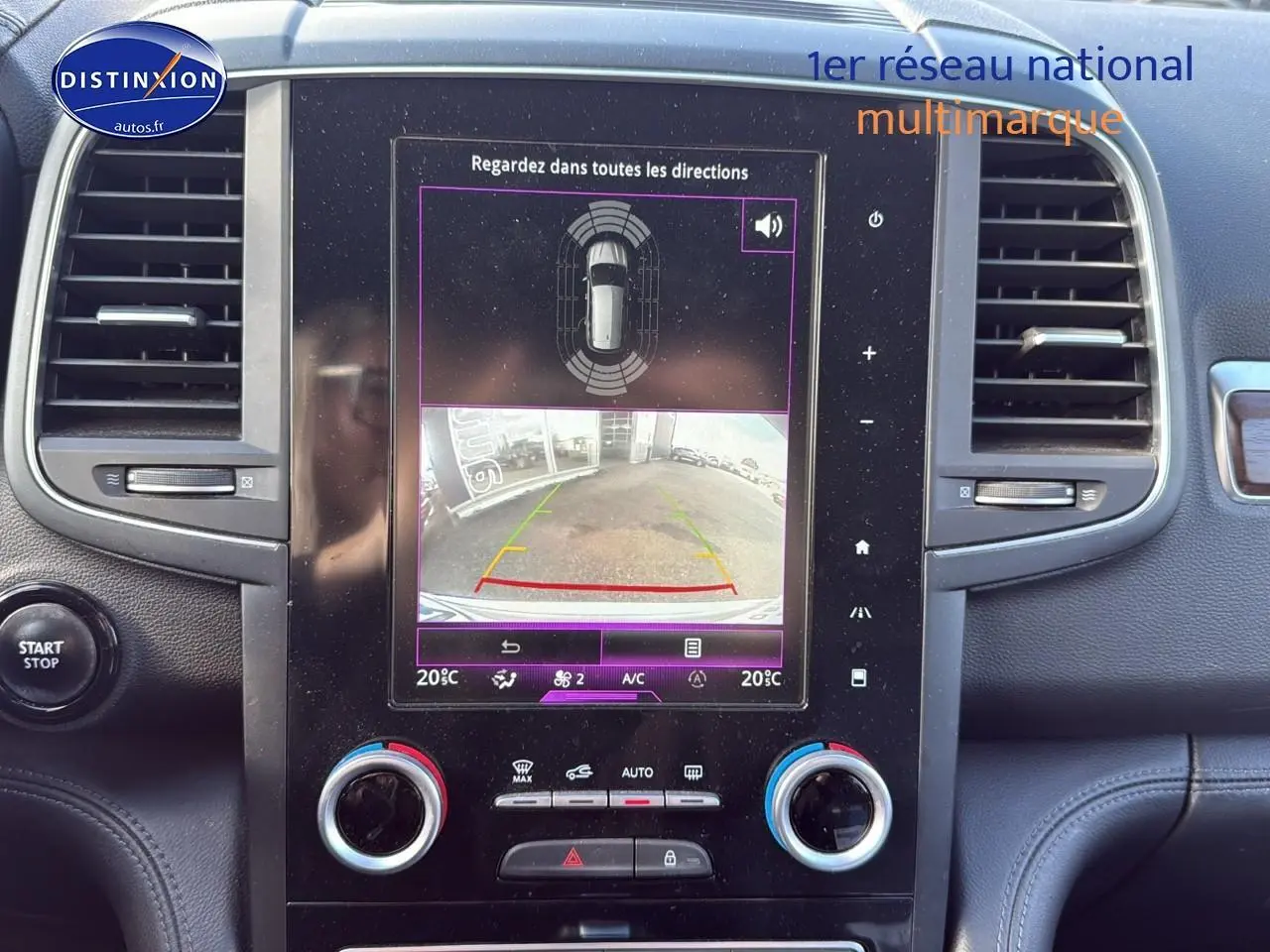 Écran tactile central montrant la caméra de recul du Renault Koleos gris, tableau de bord noir avec aérateurs latéraux.