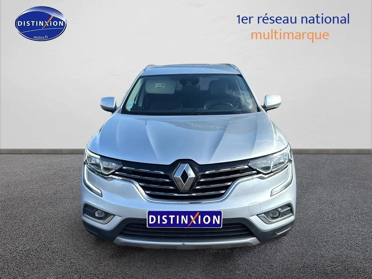 Vue frontale d'un Renault Koleos gris 2017 avec calandre noire et feux LED distinctifs allumés.