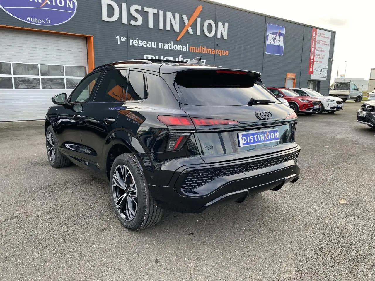 Audi Q3 2025 noir mythic métallisé en 3/4 arrière droit, avec jantes sport noires et feux LED distinctifs.