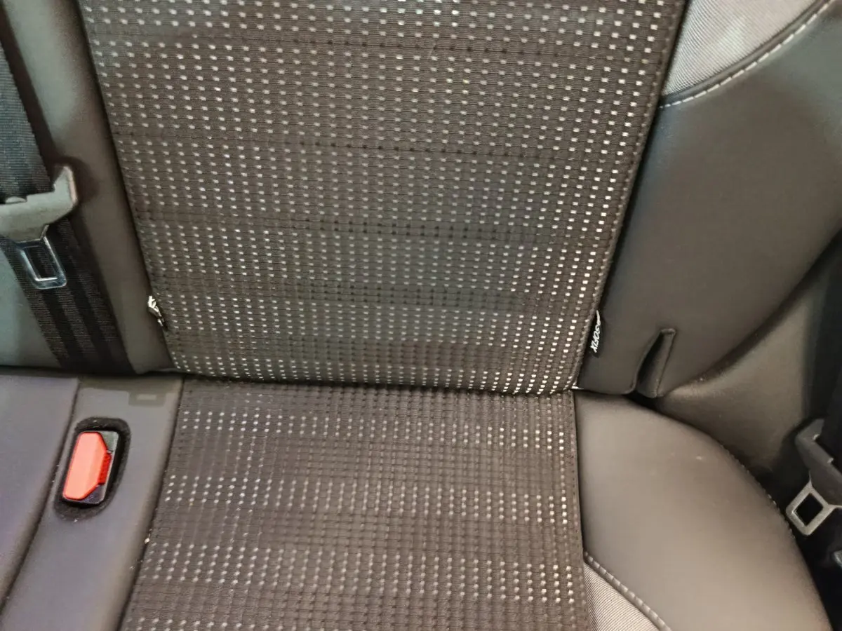 Gros plan sur la banquette arrière gris foncé du Peugeot 2008 avec ceinture et bouton d'attache visible.