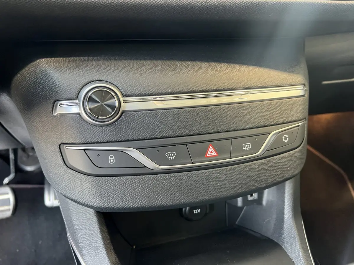 Gros plan sur la console centrale noire de la Peugeot 308 GT Line 2019 avec commandes de verrouillage et climatisation.