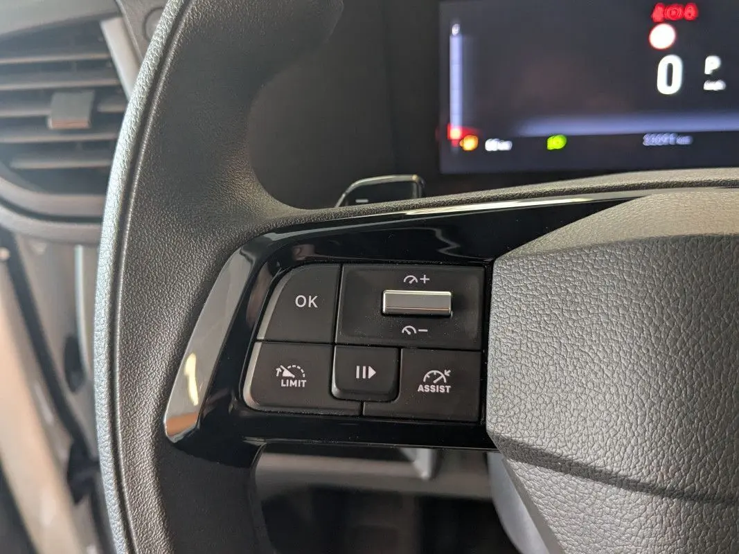 Gros plan sur les commandes à gauche du volant du Fiat Scudo Fourgon blanc, avec boutons de régulateur et assistant de conduite.