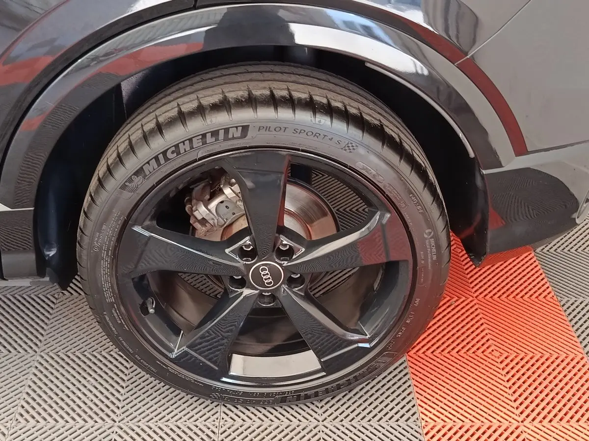 Gros plan sur la roue arrière droite noire d’un Audi Q2 35 TFSI S Line avec jante cinq branches et pneu Michelin.