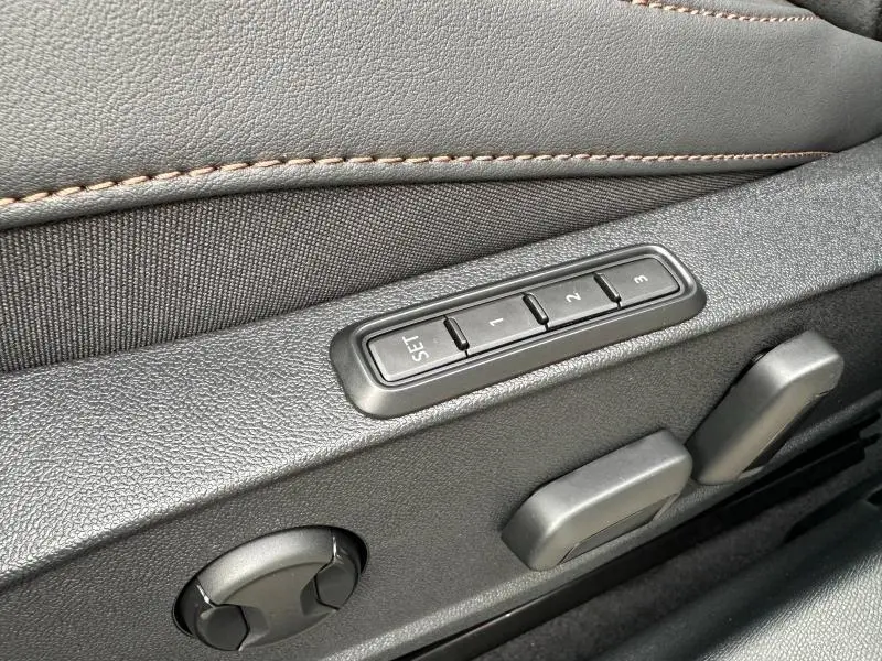 Détail des commandes de réglage de siège en textile noir avec surpiqûres marron dans une CUPRA Formentor 2026.