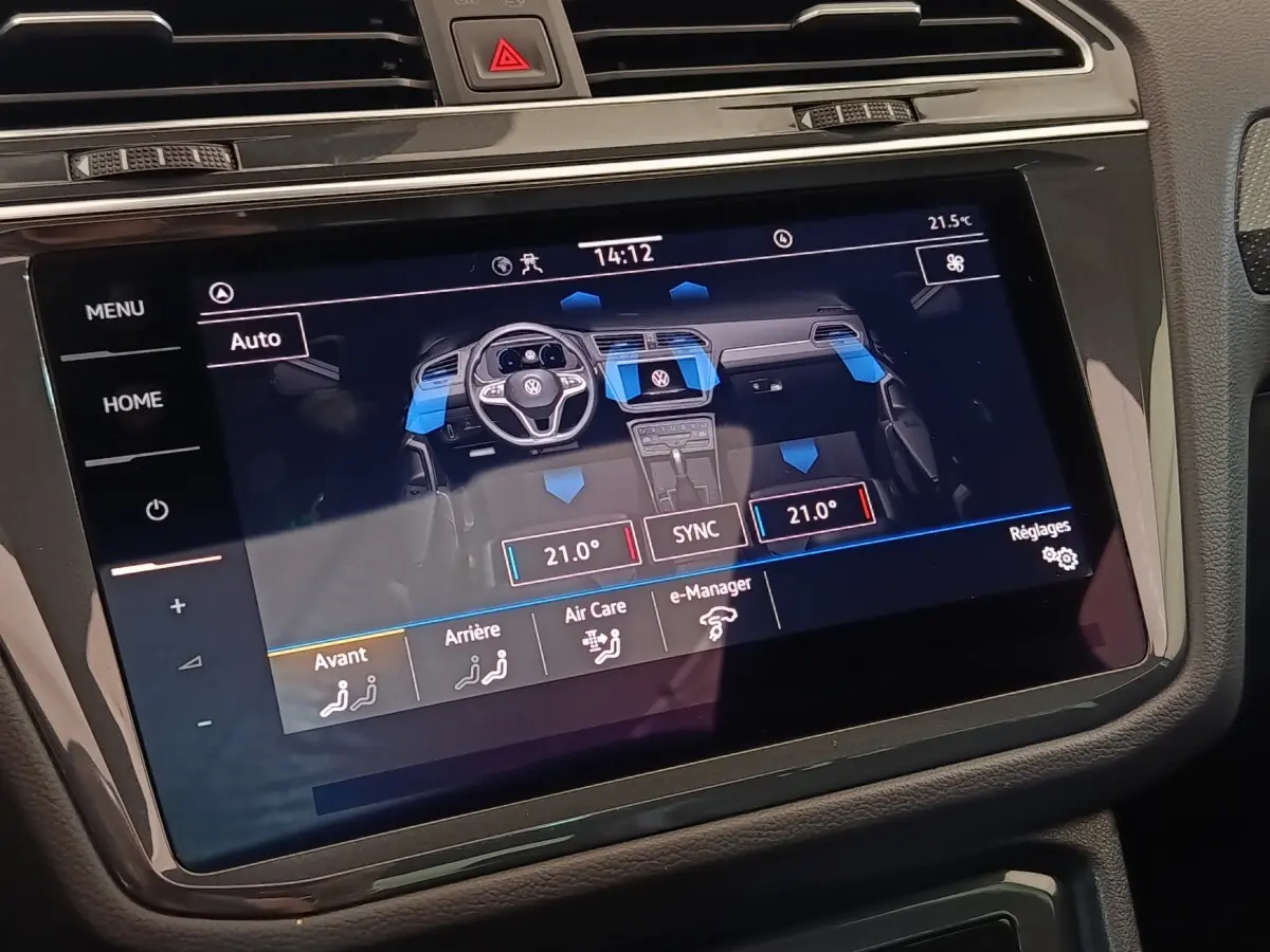 Écran tactile central du Volkswagen Tiguan blanc 2023 affichant la gestion climatique multizone intérieure.