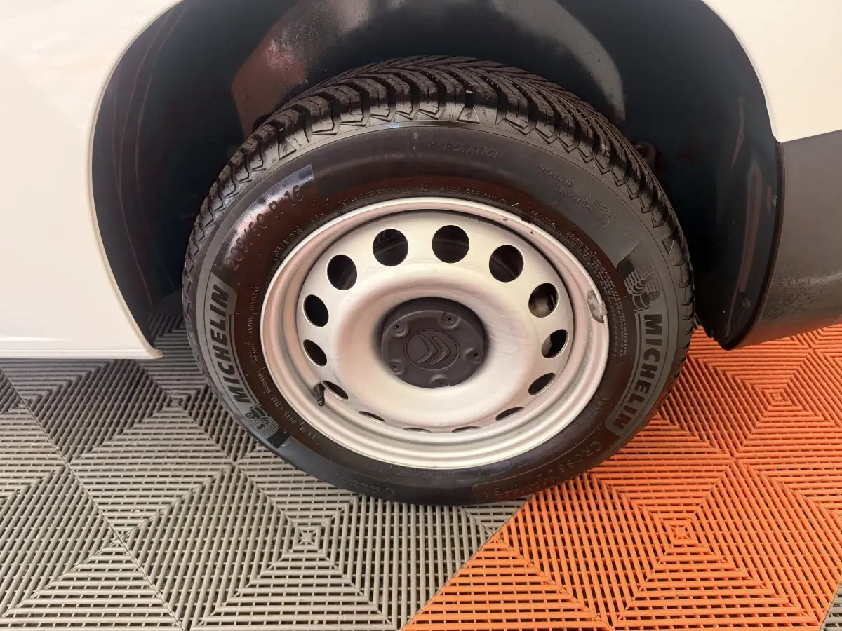 Gros plan sur la roue avant droite blanche d’un Citroën Berlingo 2022 avec jante acier et pneu Michelin.