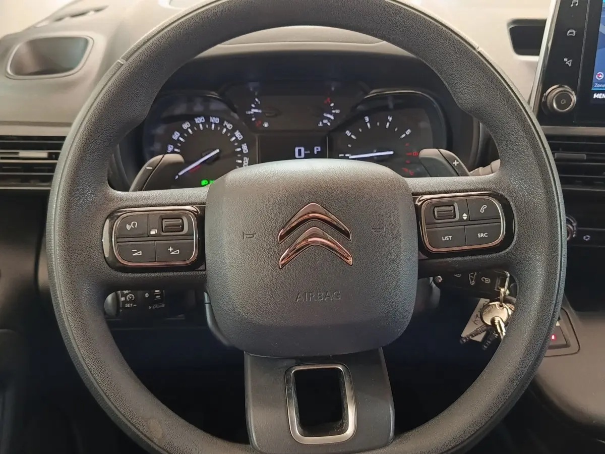 Vue rapprochée du volant multifonctions noir du Citroën Berlingo 2020 avec tableau de bord et écran tactile visibles.
