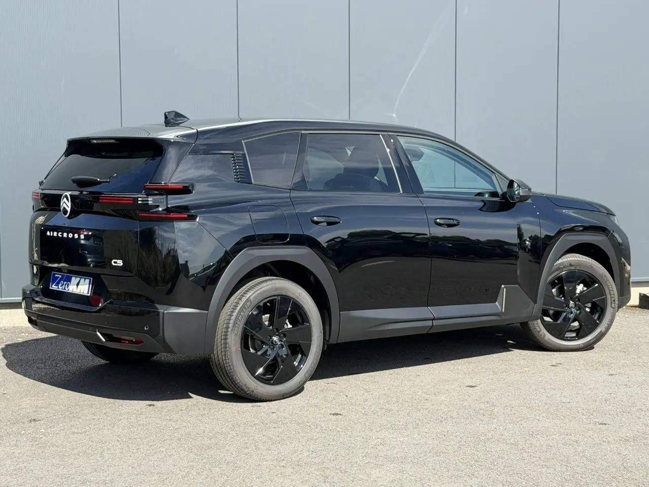Vue 3/4 arrière droite du Citroën C5 Aircross noir Perla avec jantes alliage noires et feux arrière LED distinctifs.