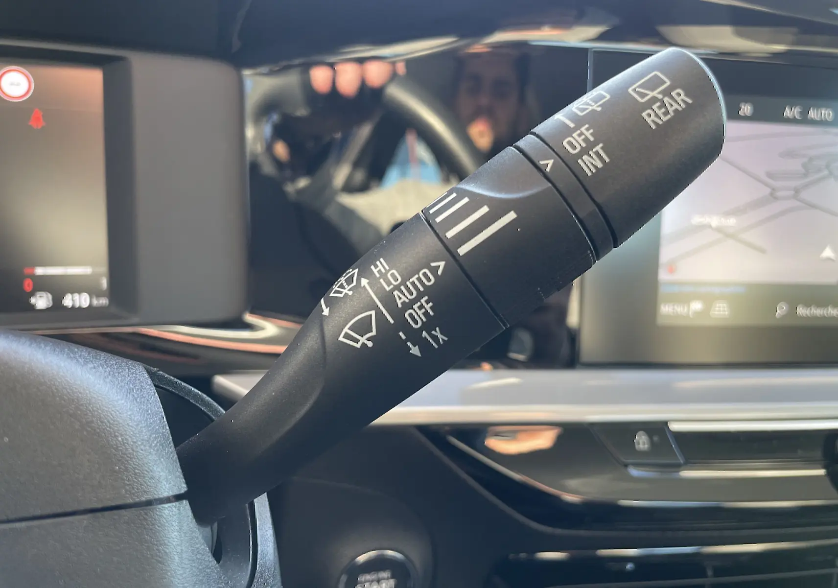 Gros plan sur la commande d’essuie-glace dans l’habitacle gris-noir d’un Opel Mokka bleu Voltak 2023.