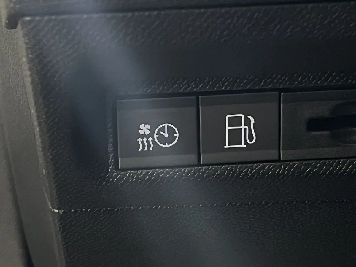 Gros plan sur les boutons de commande intérieurs du Peugeot 308 GT PHEV blanc nacré, avec symbole chauffage et carburant.