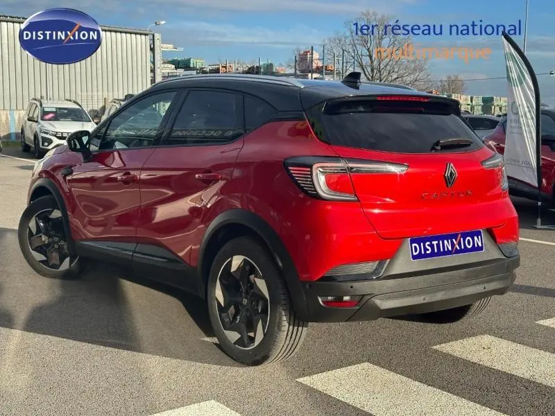 Vue 3/4 arrière droite du Renault Captur 2025 Rouge Flamme avec toit Noir Étoilé et jantes noires distinctives.