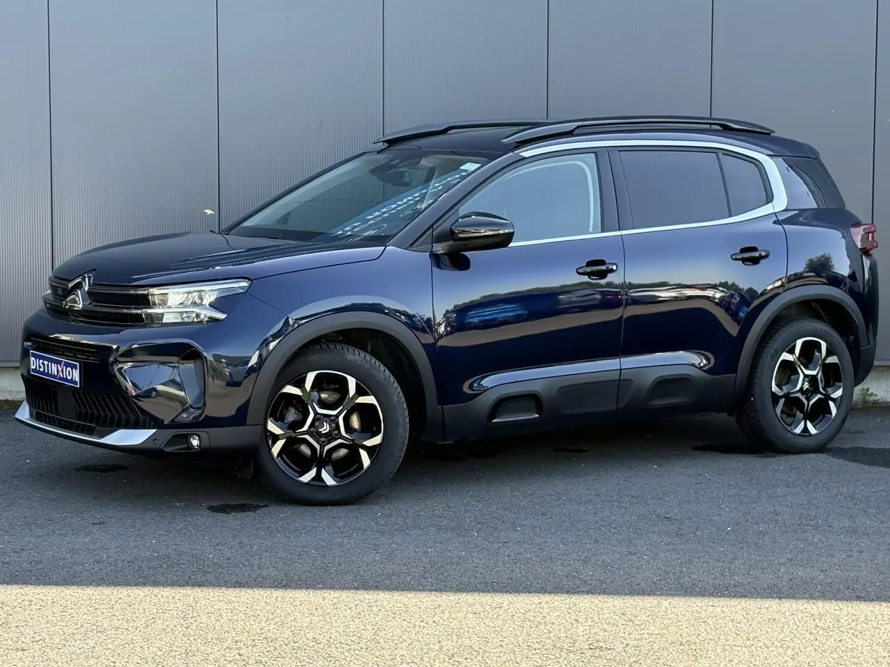 Citroën C5 Aircross Hybrid bleu Eclipse vue de profil côté gauche avec jantes alliage bi-ton et barres de toit noires.