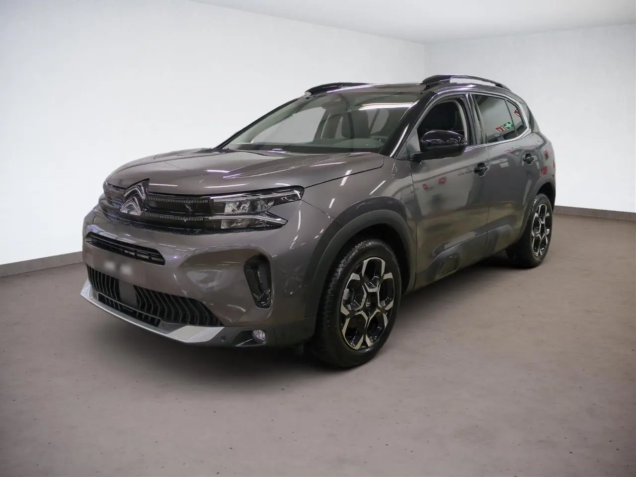 Citroën C5 Aircross Hybrid gris Platinium vue 3/4 avant droit avec jantes alliage bi-ton et barres de toit noires.