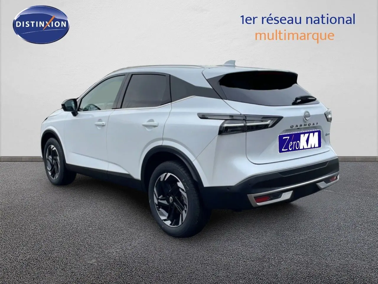 Vue 3/4 arrière droite du Nissan Qashqai blanc nacré métal avec jantes noires et vitres teintées.