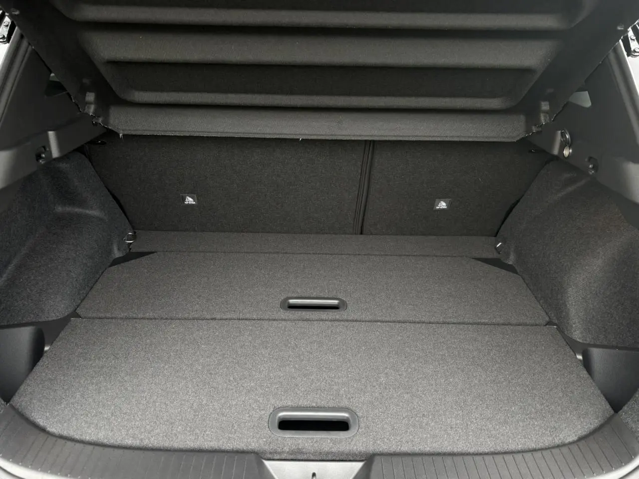 Coffre modulable du Nissan Qashqai gris Ceramic vu de l'arrière avec plancher de coffre plat et compartiments fermés.