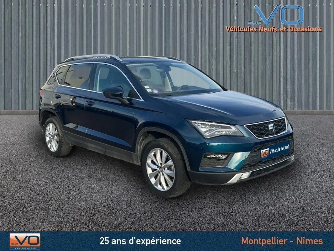 SEAT Ateca bleu foncé en 3/4 avant droit, avec jantes alliage 17 pouces et calandre chromée visible.