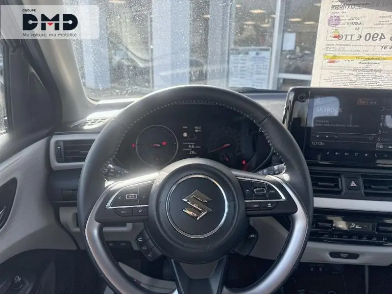 Vue centrée sur le volant cuir multifonction de la Suzuki Swift 2024, avec tableau de bord et écran tactile visibles.