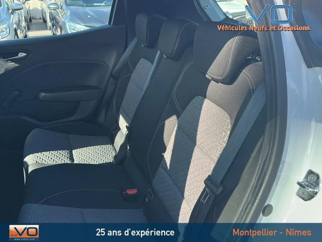 Vue intérieure côté droit montrant les sièges arrière gris et noirs d'une Renault Clio blanche 2021.