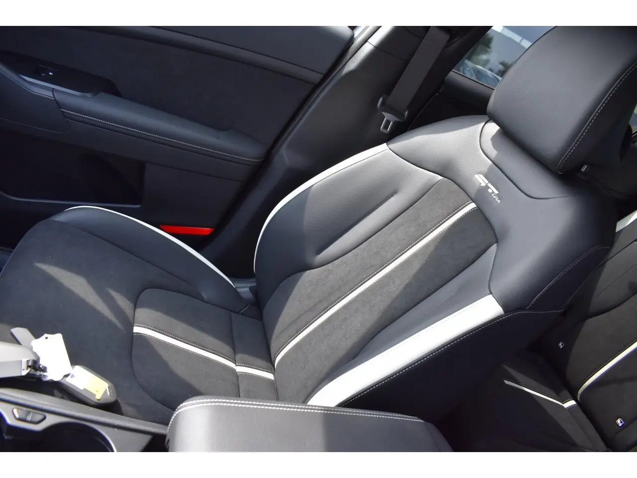 Gros plan sur le siège avant droit bi-ton noir et gris du Kia Sportage GT-Line 2026 avec logo GT-Line brodé.