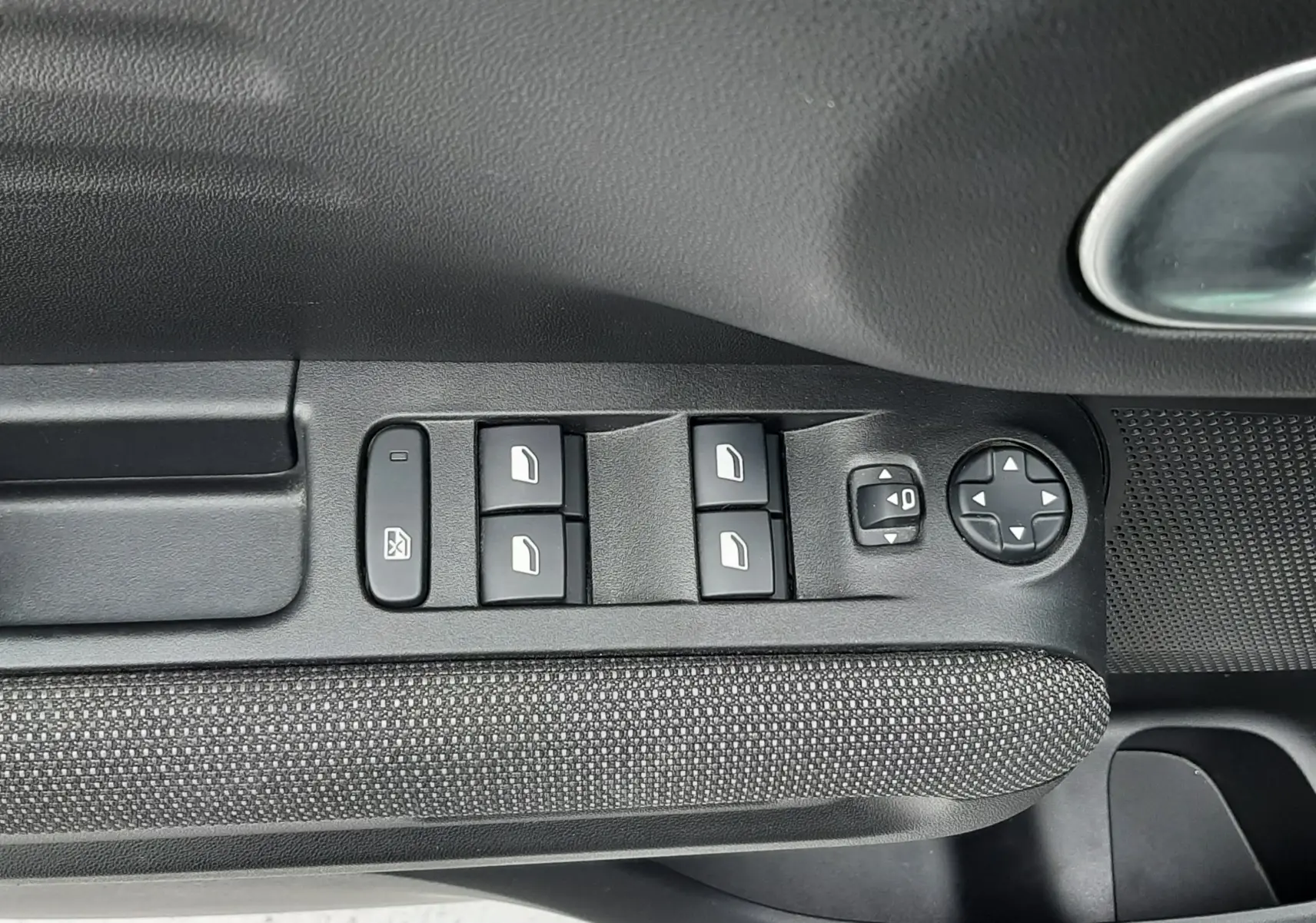 Gros plan sur les commandes des vitres électriques et réglages des rétroviseurs côté conducteur du Citroën C3 Aircross sable métal.