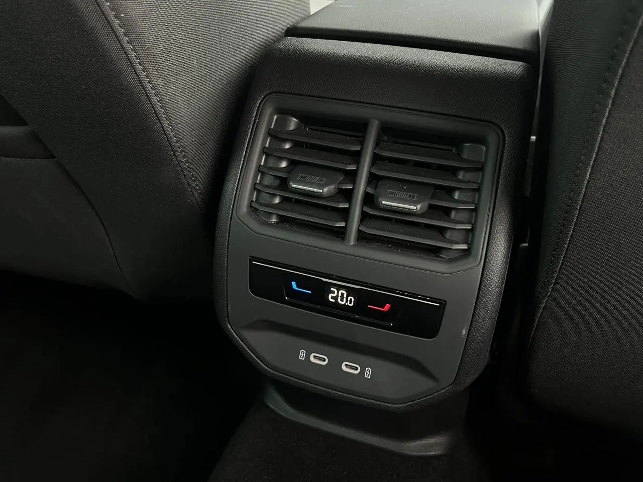 Vue rapprochée des aérateurs arrière et commandes climatisation avec prises USB C du SEAT LEON 2024 noir Minuit.