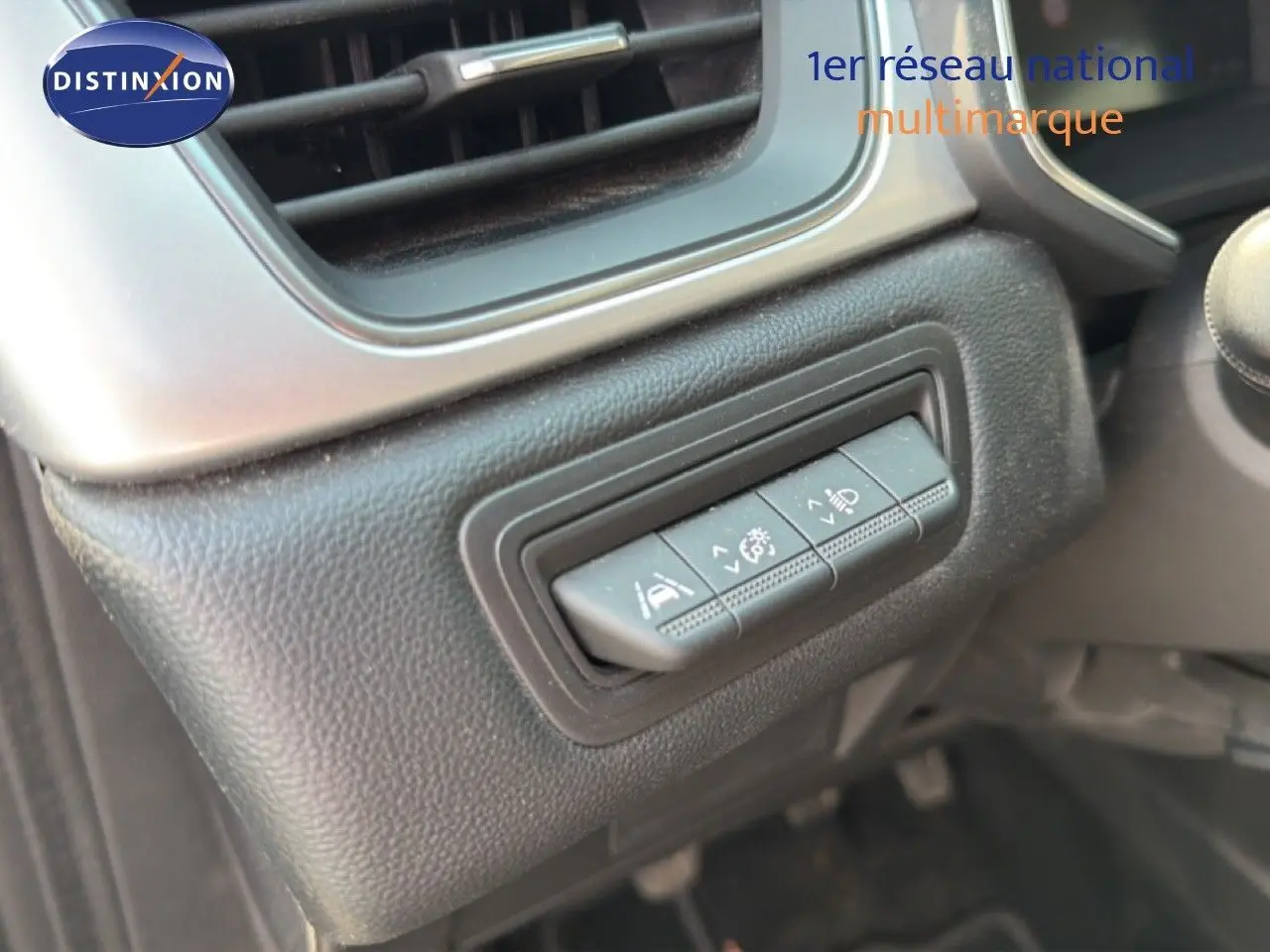 Détail des commandes d'assistance au conducteur sur le tableau de bord du Renault Captur bleu marine fumé 2022.