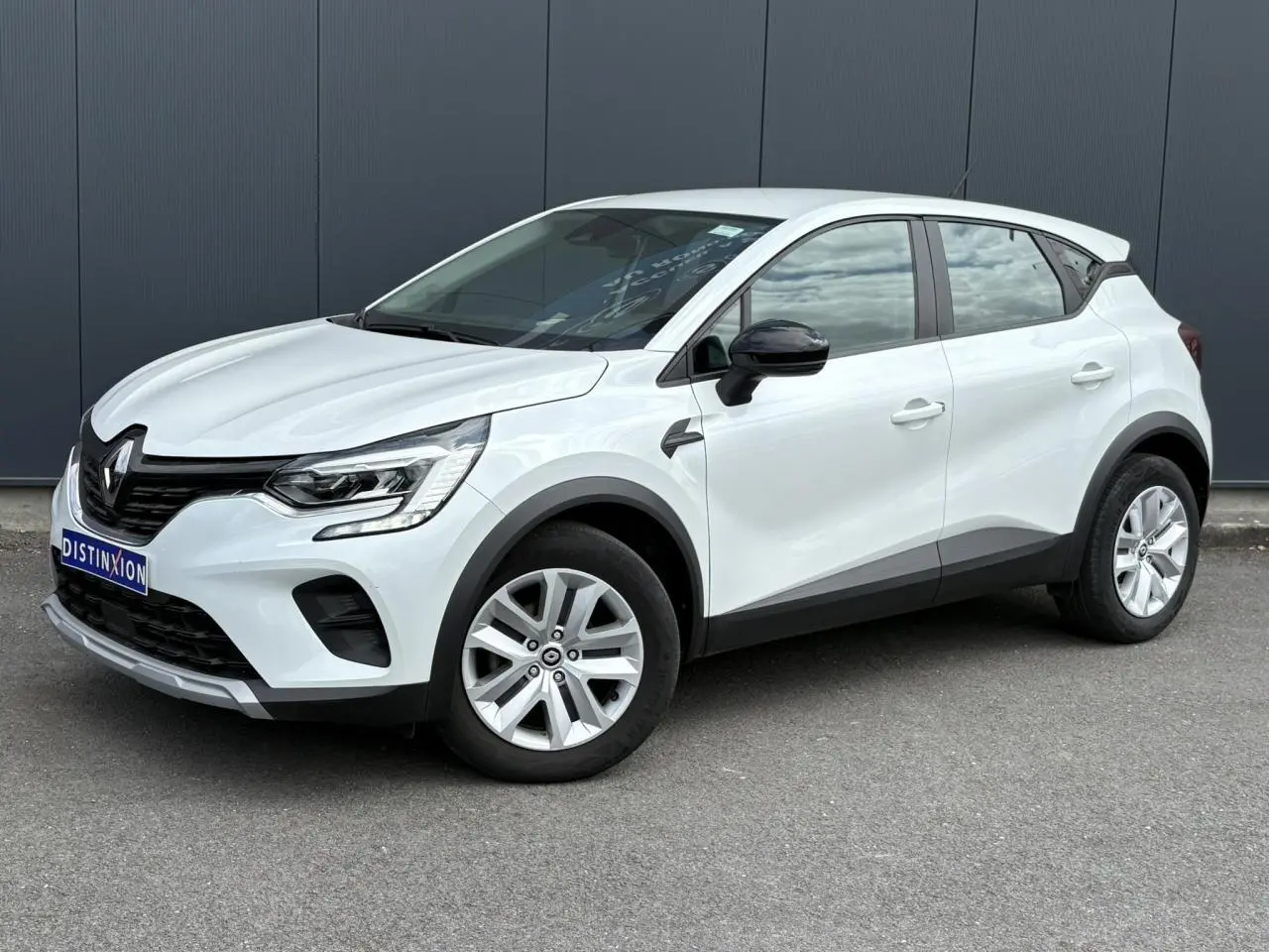 Renault Captur TCE 90 Business blanc nacré en 3/4 avant droit avec jantes alliage et rétroviseurs noirs.