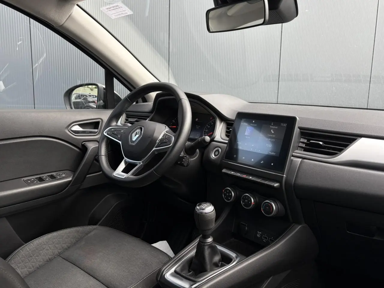 Intérieur du Renault Captur TCE 90 Business 2022, vue côté conducteur, volant multifonction et écran tactile Easy Link.