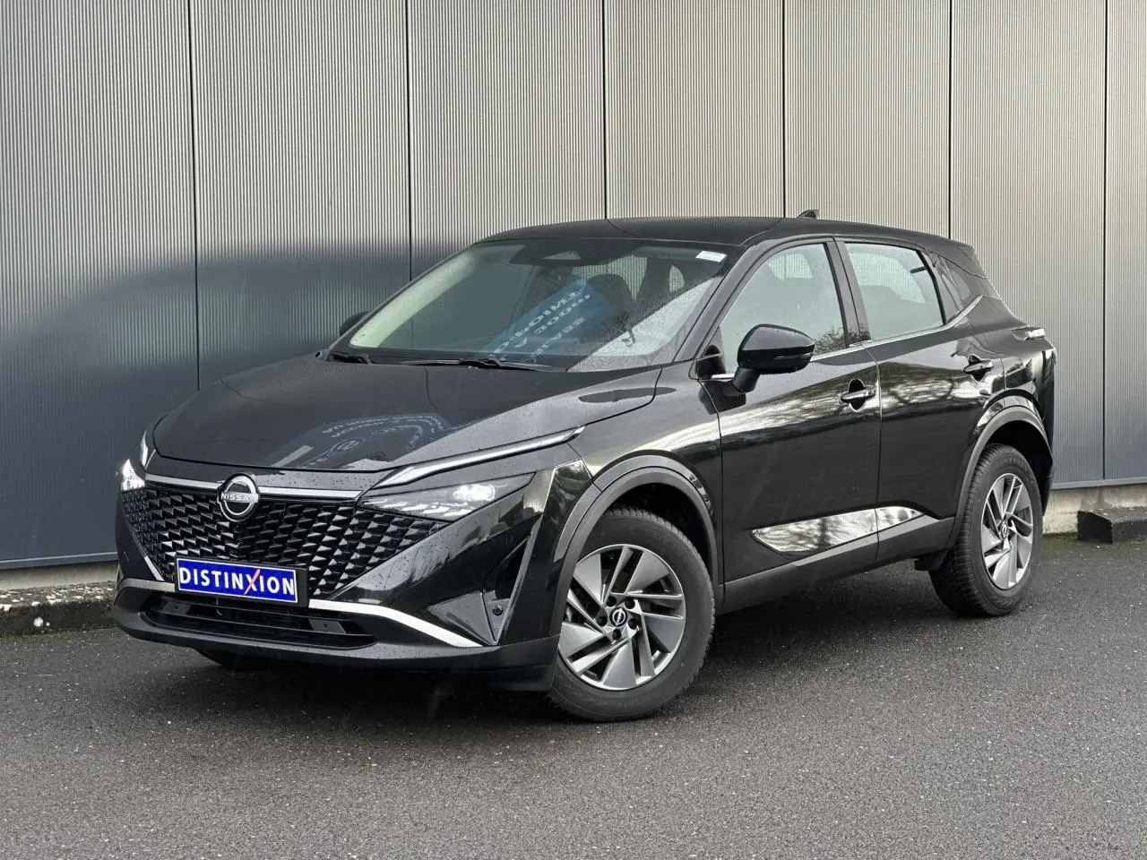 Nissan Qashqai noir nacré vu en 3/4 avant droit, avec calandre distinctive et jantes alliage 17 pouces.