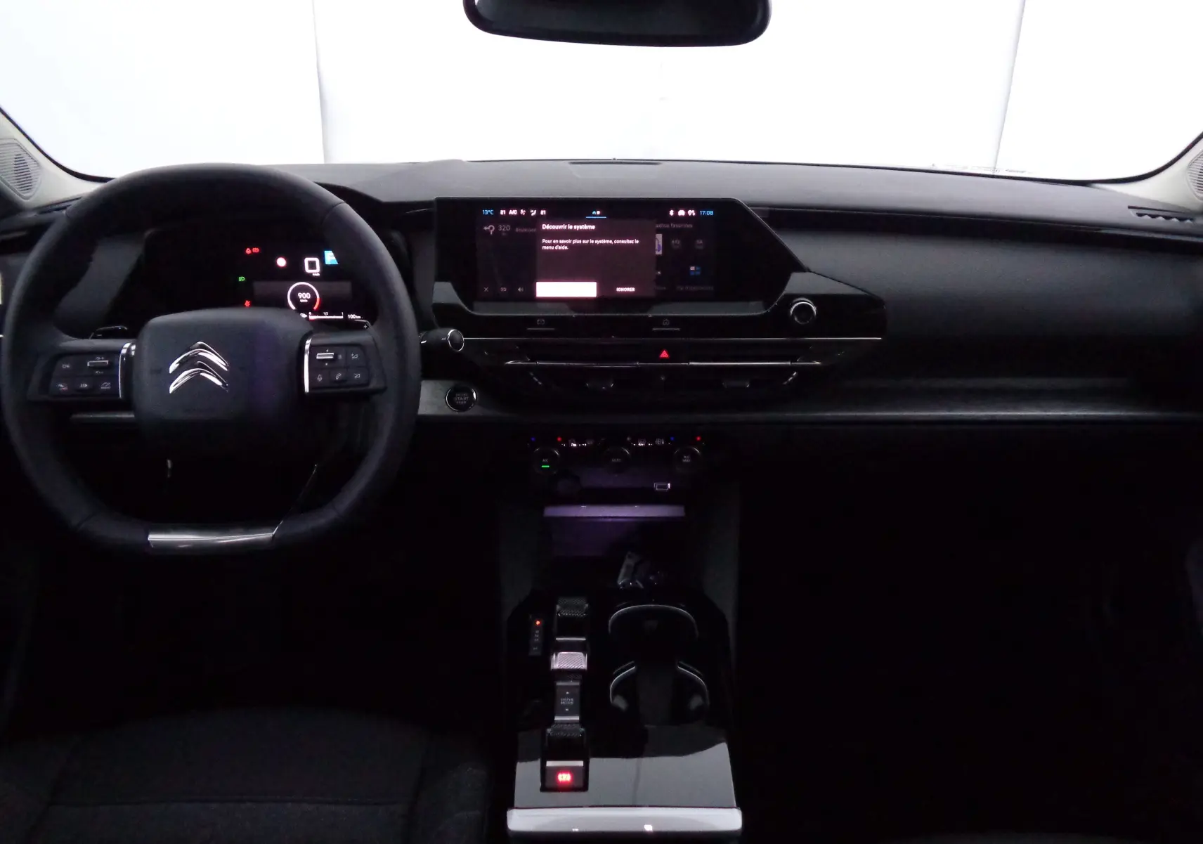 Vue intérieure frontale du tableau de bord noir du Citroën C5 X 2023 avec écran tactile et volant multifonction.