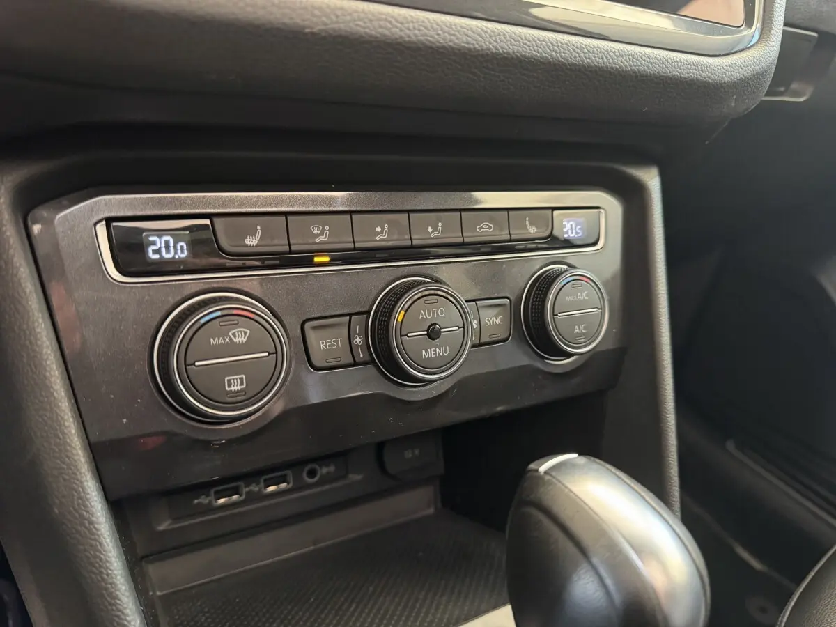 Gros plan sur la console centrale noire du Volkswagen Tiguan Allspace 2019, montrant les commandes de climatisation et la boîte auto.