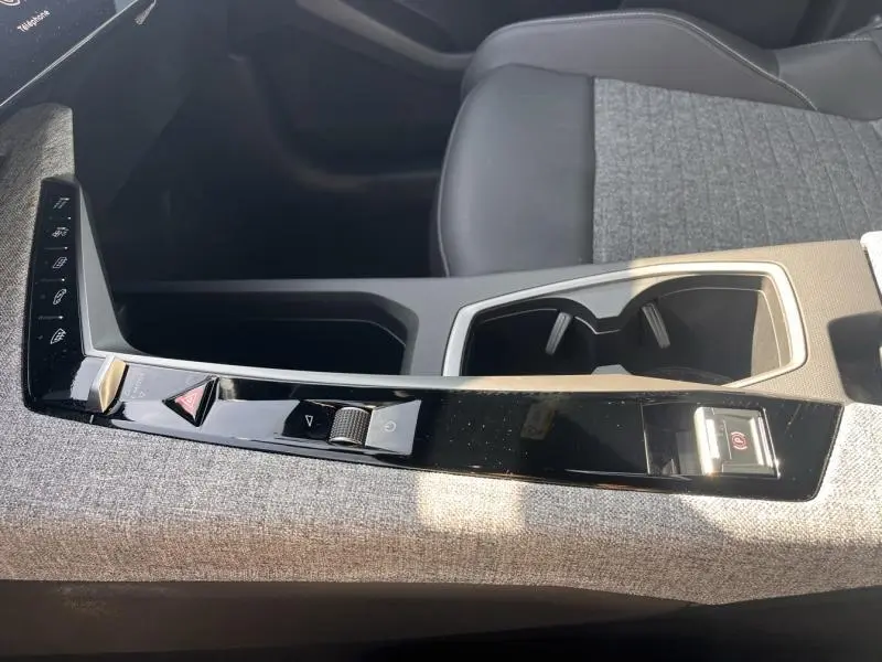 Détail de la console centrale côté droit du Peugeot 3008 gris Artense, avec commandes tactiles et accoudoir en tissu gris.