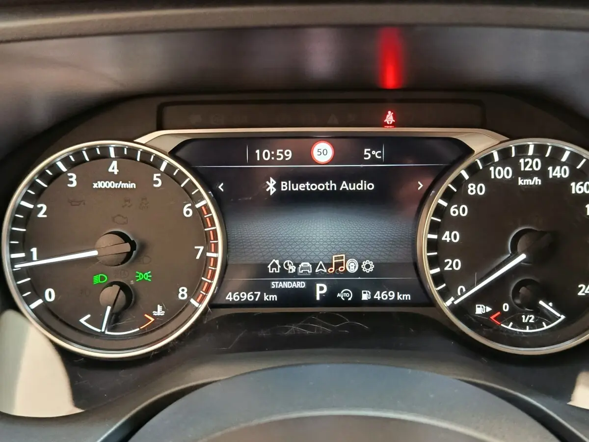 Vue rapprochée du combiné d'instruments du Nissan Qashqai 2022 affichant la vitesse, le régime moteur et l'écran central Bluetooth.