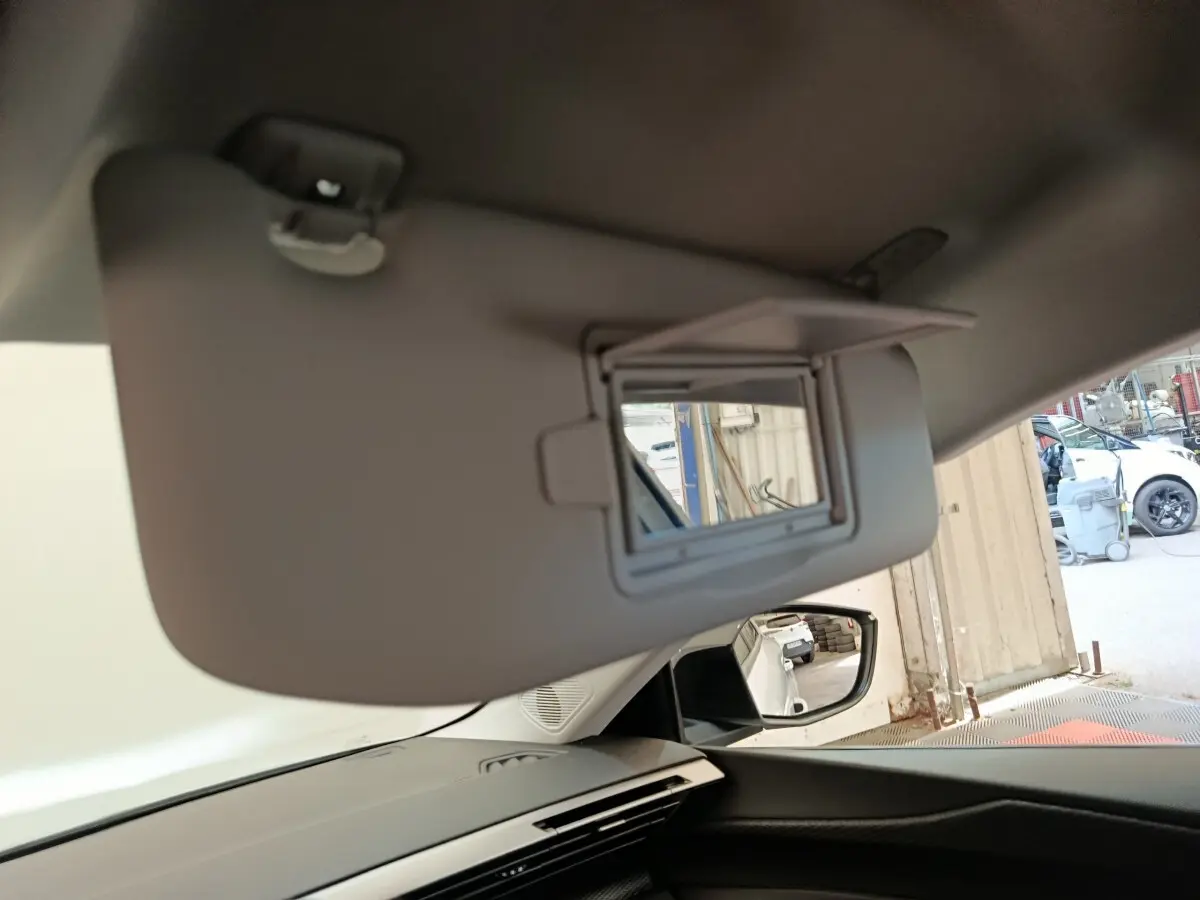 Détail du pare-soleil avec miroir intégré côté conducteur dans le blanc intérieur d'une Peugeot 308 2024.
