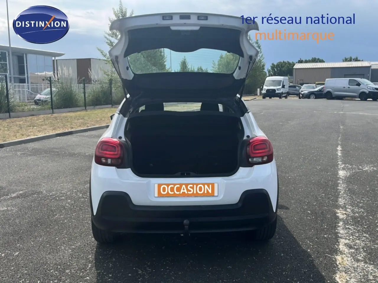 Vue arrière d'une Citroën C3 blanche de 2018 avec coffre ouvert, feux arrière rouges et pare-chocs noir.
