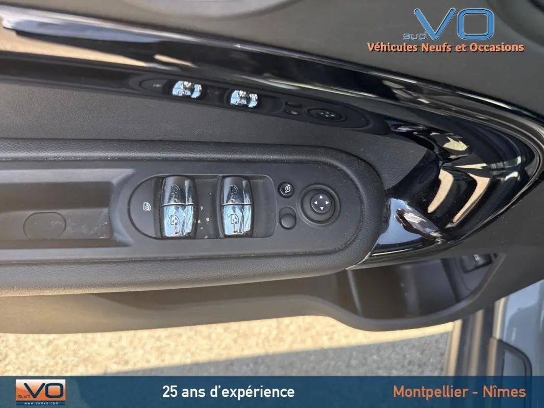 Gros plan sur les commandes de lève-vitres et rétroviseurs côté gauche d'une MINI Countryman gris clair 2021.