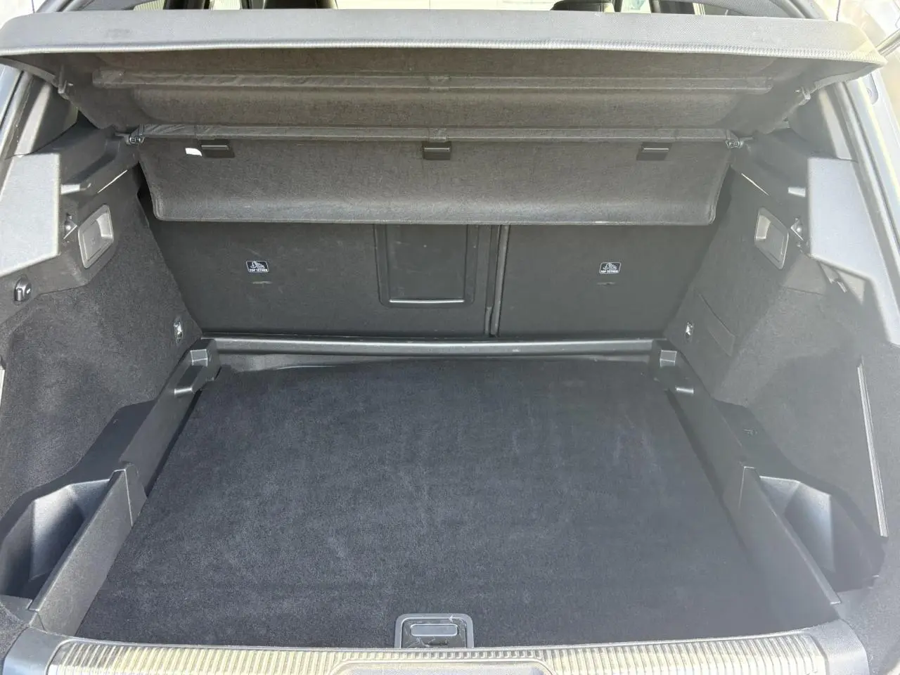 Coffre ouvert du DS7 1.6 E-Tense 225 en vue arrière, montrant un espace de chargement propre et bien fini.