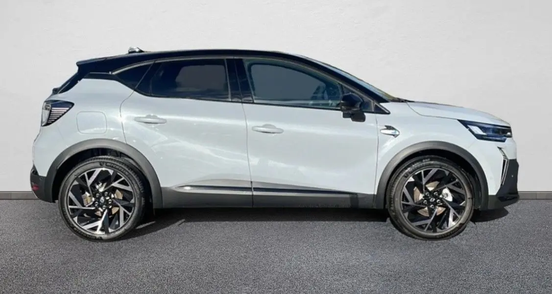 Renault Captur II Ph.2 blanc nacré en profil droit, avec toit noir et jantes alliage bi-ton distinctives.