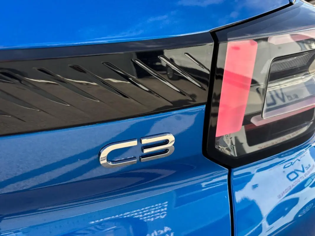 Gros plan sur l'arrière droit bleu vif du Citroën C3 2025, mettant en valeur le logo C3 et le feu arrière moderne.