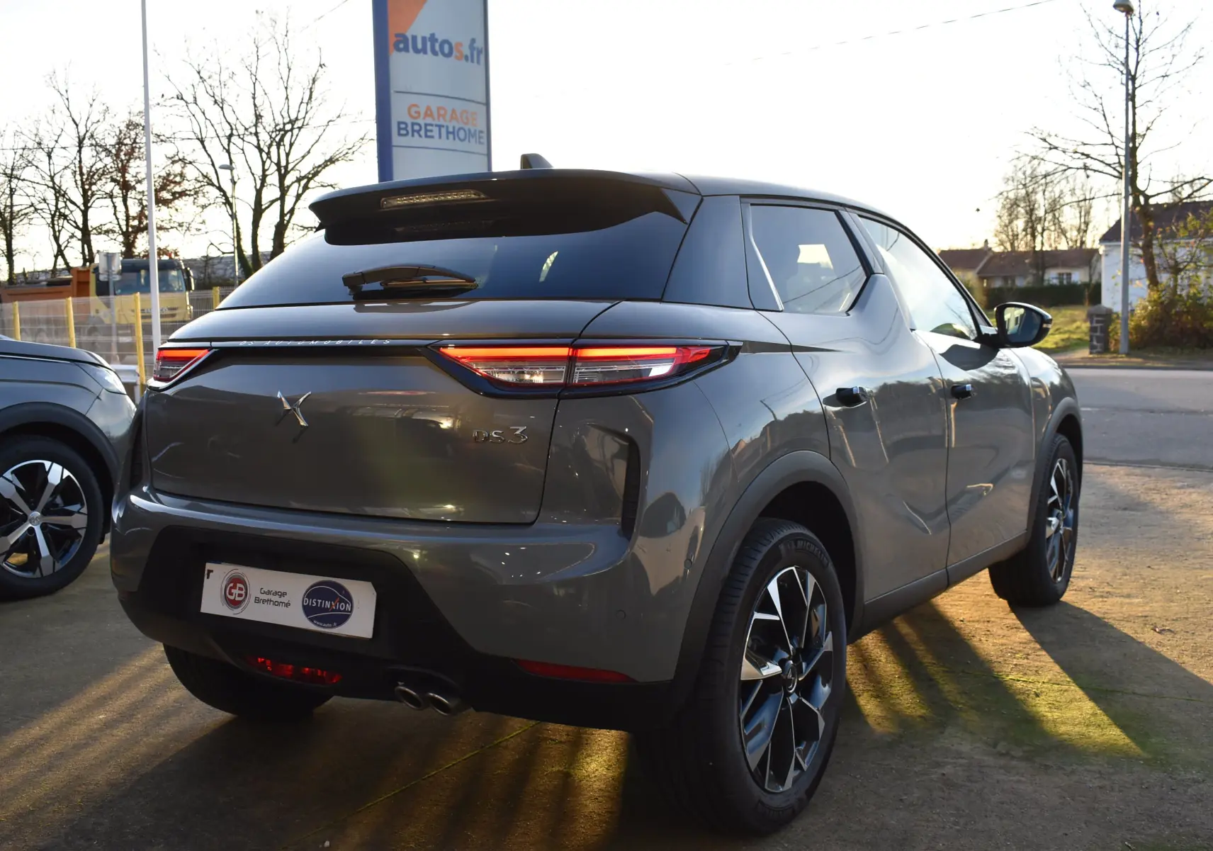 Vue 3/4 arrière droite d'un DS3 Crossback gris métallisé 2024 avec feux LED et jantes alliage distinctives.
