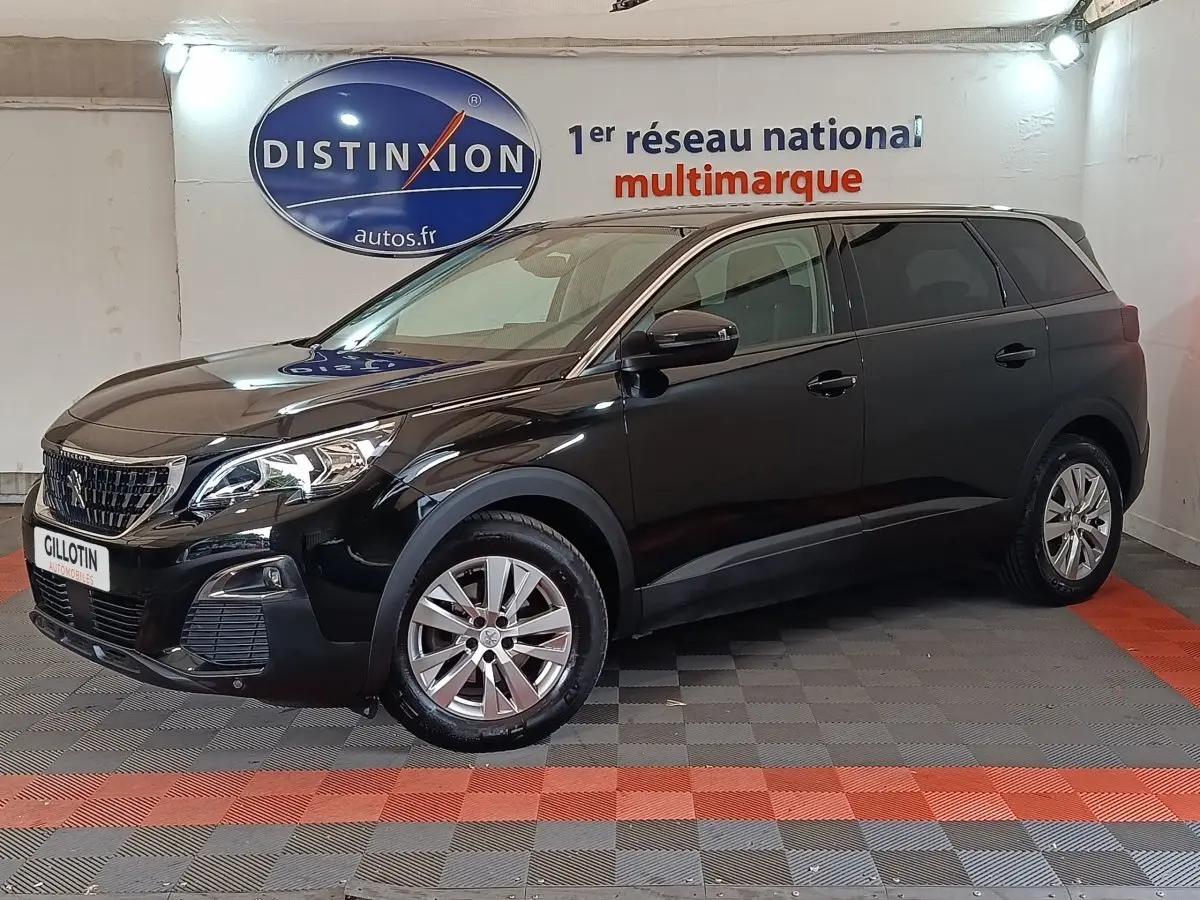 Peugeot 5008 noir en 3/4 avant droit, SUV familial avec jantes alliage et calandre distinctive Peugeot.