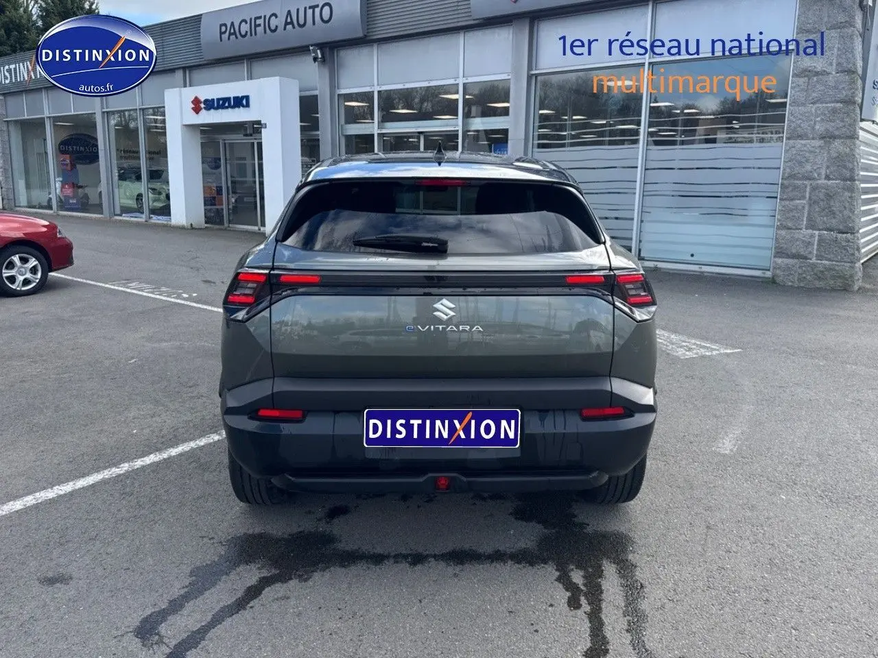 Vue arrière du Suzuki Vitara 2026 électrique en vert Land Breeze avec toit noir, feux LED et logo eVITARA visible.