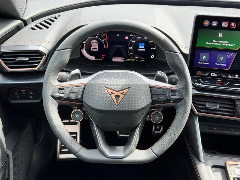 Vue intérieure centrée sur le volant cuir perforé gris et le tableau de bord numérique du CUPRA Formentor bleu 2026.