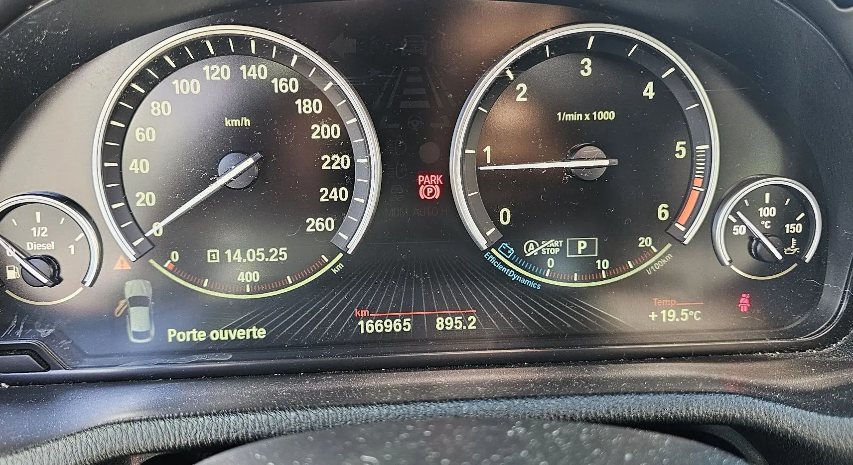 Tableau de bord du BMW X4 xDrive20dA 2015 montrant compteurs, jauge diesel et alertes, avec affichage noir et jaune.